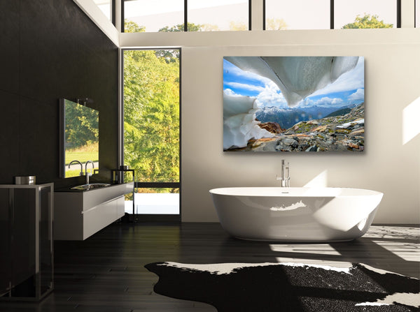 Ice cave photography canvas hangs in a bathroom above a soaker tub. Photography by Shel Neufeld.