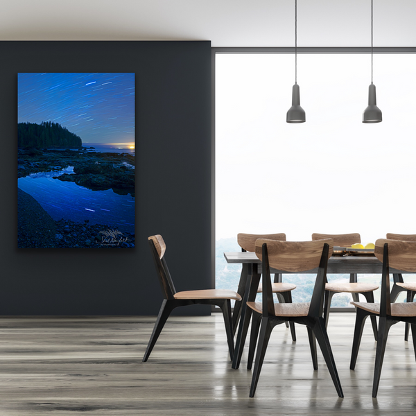 Vertical Sombrio Beach Astrophotography print hangs in a living room. Artwork by Shel Neufeld, Canadian landscape and nature photographer. 