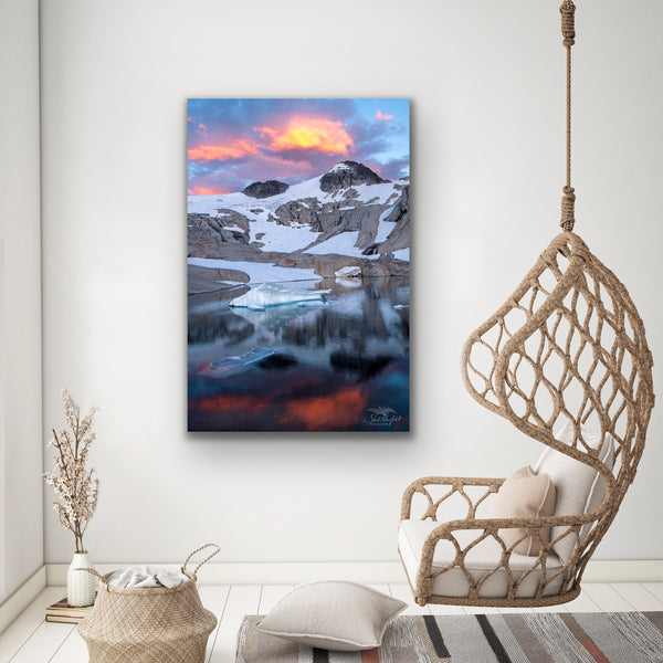 Vertical mountain sunset canvas hangs in a living room. Photography by Shel Neufeld. 