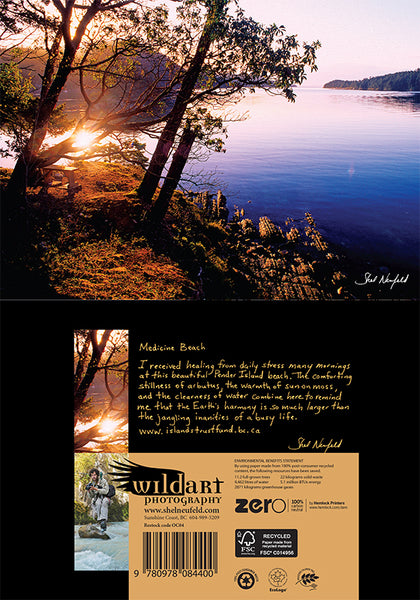Sunrise captured over a beach named Medicine Beach. The sun peaks through trees and reflects on the blue/purple water. There are hills in the background. This photograph is made into a blank greeting card. On the back of the card is a short story about the location by the photographer, Shel Neufeld of Roberts Creek, BC, Canada.