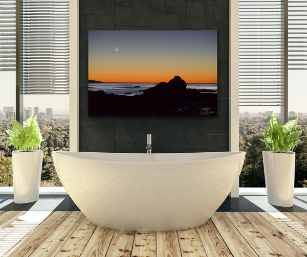 Sombrio sunset photography canvas by photographer Shel Neufeld hangs in a bathroom scene above a white soaker tub. 