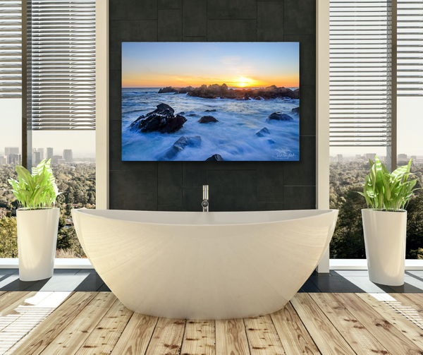 Ucluelet Big Beach Coastal Landscape Photography Canvas hangs on a bathroom wall above a big white soaker bathtub. The colourful photography image contains a warm sunset over a rocky coastal ocean landscape. This image is meant to visualize what the canvas may look like in a bathroom setting. Artwork by Canadian landscape photographer, Shel Neufeld of Roberts Creek, BC. 