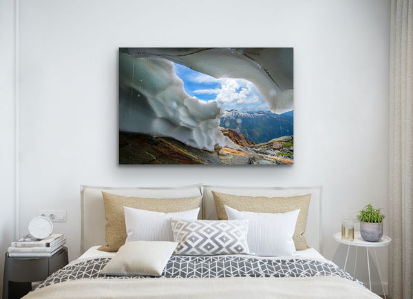 Ice Cave in Mountain photography canvas hangs in a bedroom above a bed. This nature landscape is by Shel Neufeld, Canadian photographer. 