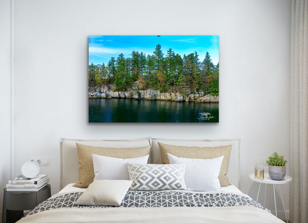 Seascape photography canvas hangs on a wall above a bed. Photography by Shel Neufeld. Print and Canvas available in a variety of sizes. 