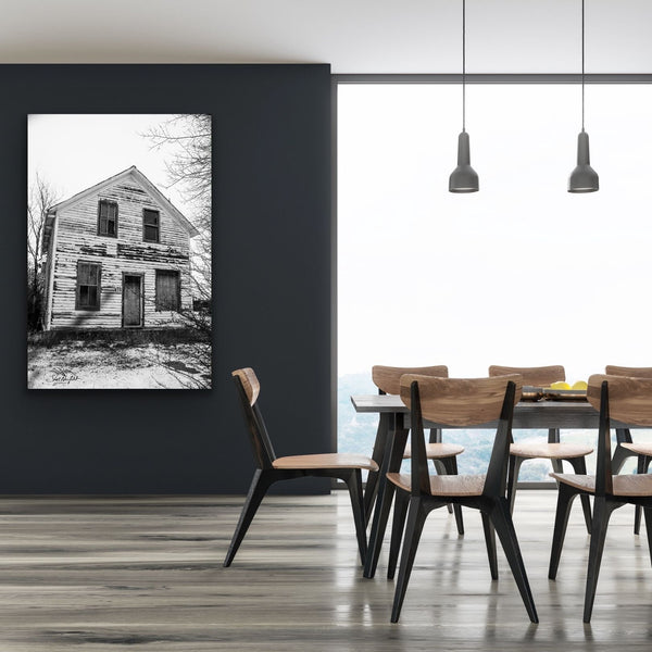 Black and white abandoned house photography canvas hangs in a living room. Artwork by Shel Neufeld, Canadian photographer from Roberts Creek. 