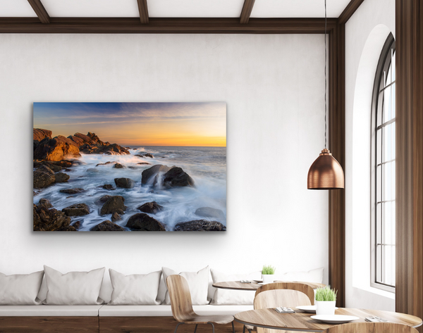 Ucluelet Waves Canvas Wall art hangs above a large wall couch in a living room scene. The canvas is a large piece measuring 40x60 inches and takes up space as a feature piece of art. Photography Canvas by Shel Neufeld, Canadian landscape and nature photographer. 