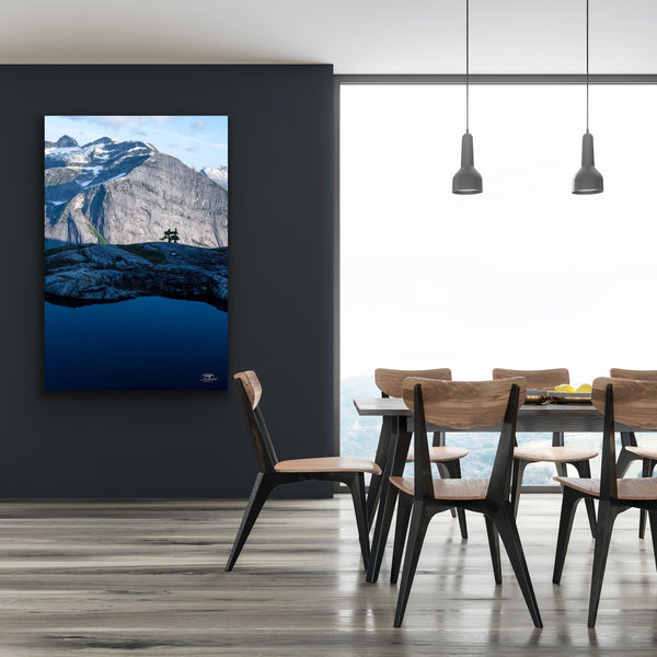 Vertical mountain landscape canvas hangs in a dining room. Photography by Shel Neufeld.