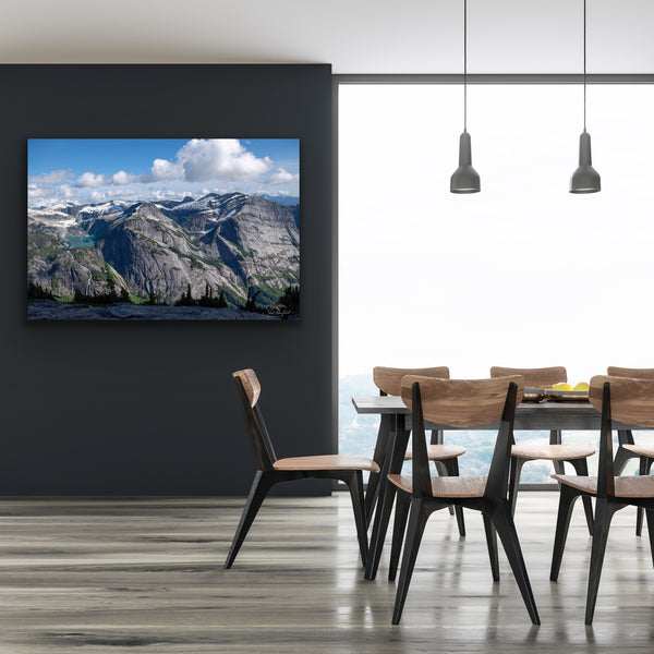 Mountain landscape canvas wall art hangs in a dining room. Photography by Shel Neufeld. 