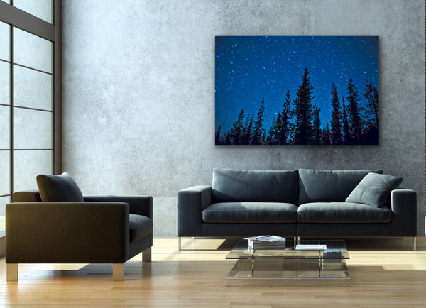 An astrophotography canvas hangs in a living room. This fine art photography print is by Shel Neufeld from Roberts Creek, BC, Canada. 