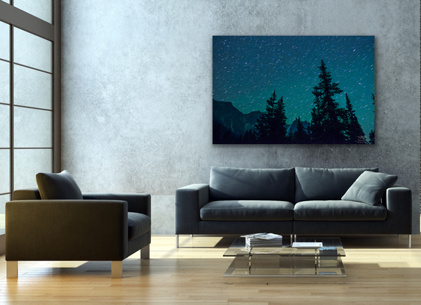 Mountain landscape astrophotography canvas hangs in a living room. Photography by Shel Neufeld. 