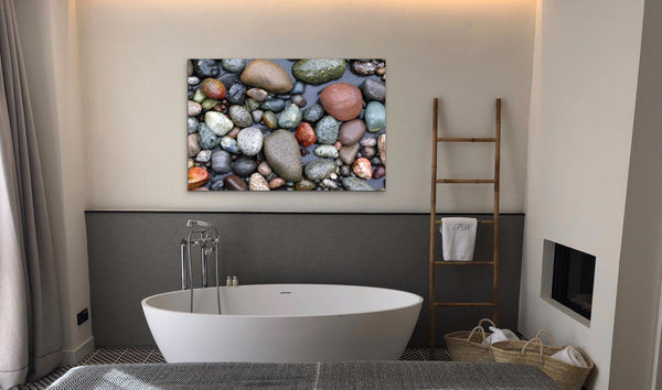 Stone beach photography canvas hangs in a bathroom scene. Artwork by Shel Neufeld, Canadian landscape and nature photogrpaher. 