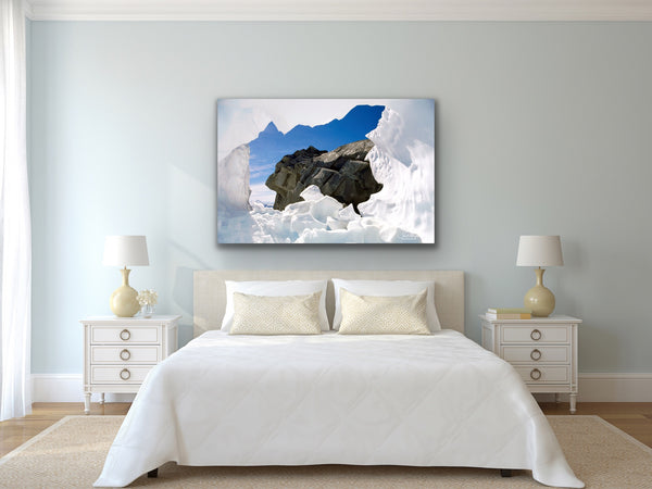Snow ice cave by Shel Neufeld photography canvas hangs in a bedroom. 