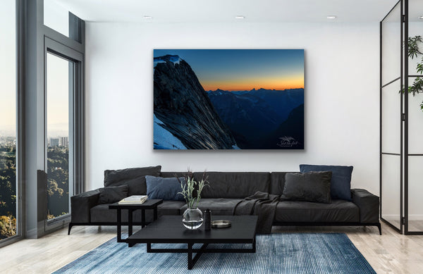 Large mountain sunset photography canvas hangs in a living room. BC Coastal Mountain landscape captured by Shel Neufeld. 